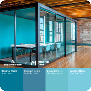 An office conference room table and chairs sits inside a separate glass box office with one solid wall painted blue and the remaining walls are glass. The box sits within an office space with hardwood floors and wood ceiling panels. At the bottom of the image are 4 swatches of various shades of blue Benjamin Moore paint. 