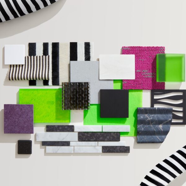 A collection inspired by the movie Beetlejuice highlighting a variety of material such as black and white stripes, neon greens, and pops of pink and purple in a variety of materials and textures.