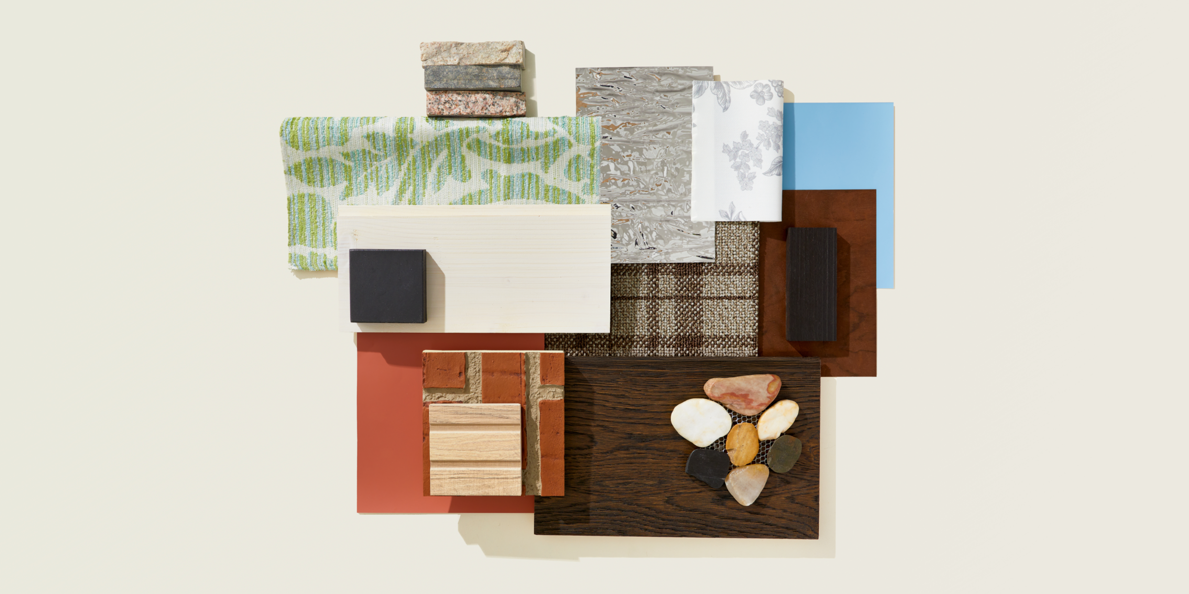 A flat lay inspired by American Colonial design featuring, wood, brick, stone, and pops of color in green and blue in a variety of materials.