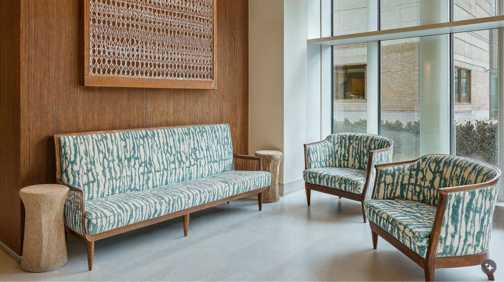 An Egyptian revival healthcare center with wood wall paneling, marble flooring, and upholstered furniture.