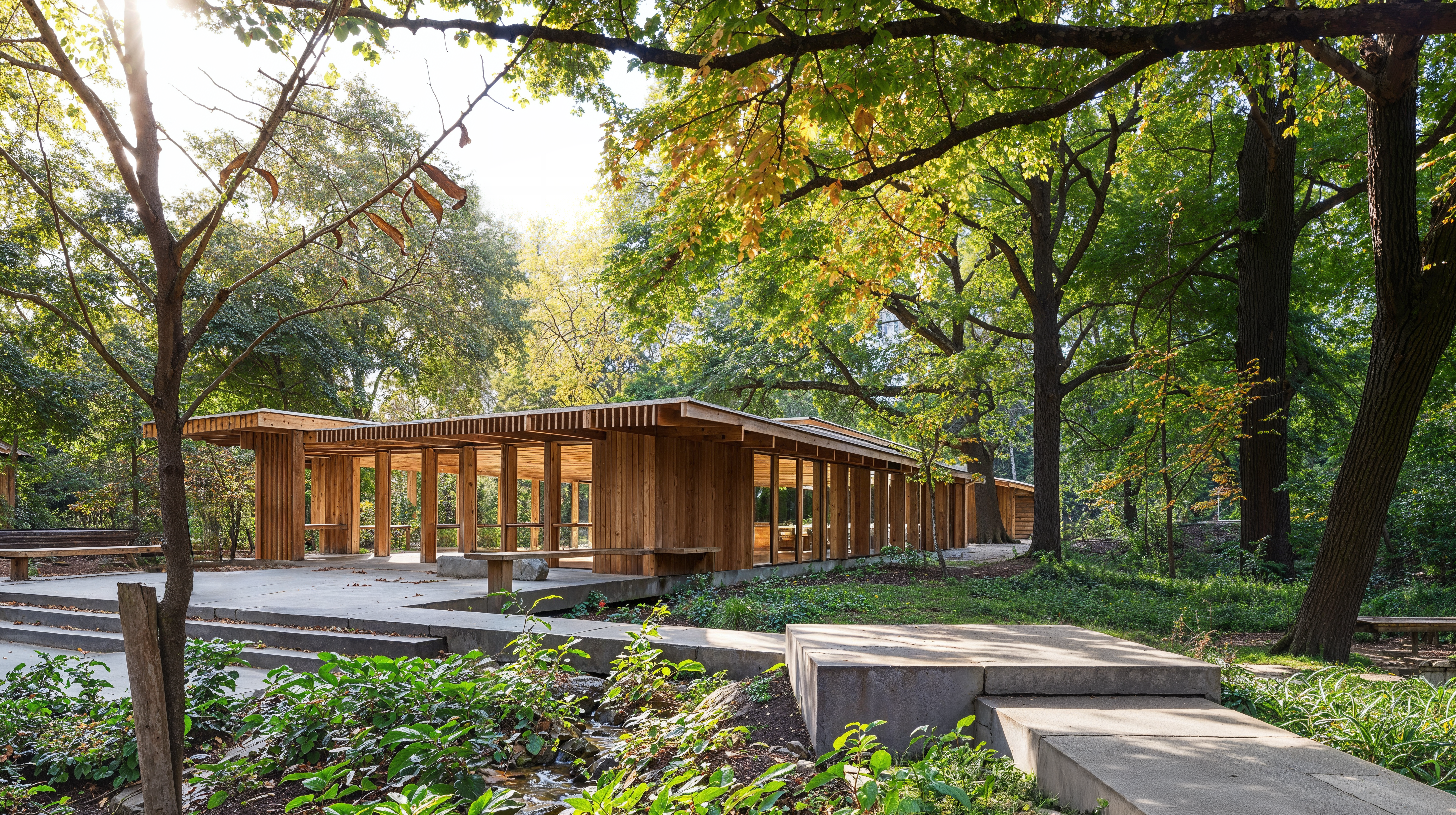 Outdoor classrooms made of wood, open area, wooden benches, surrounded by nature and concrete pathways.