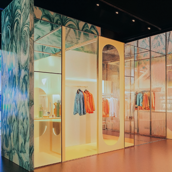 An experiential pop-up space with colorful wall paneling, LED lighting, and modular wall systems.