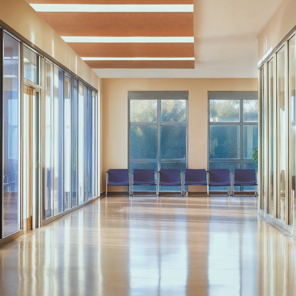 A healthcare space with innovative lighting, vinyl flooring, and blue chairs.