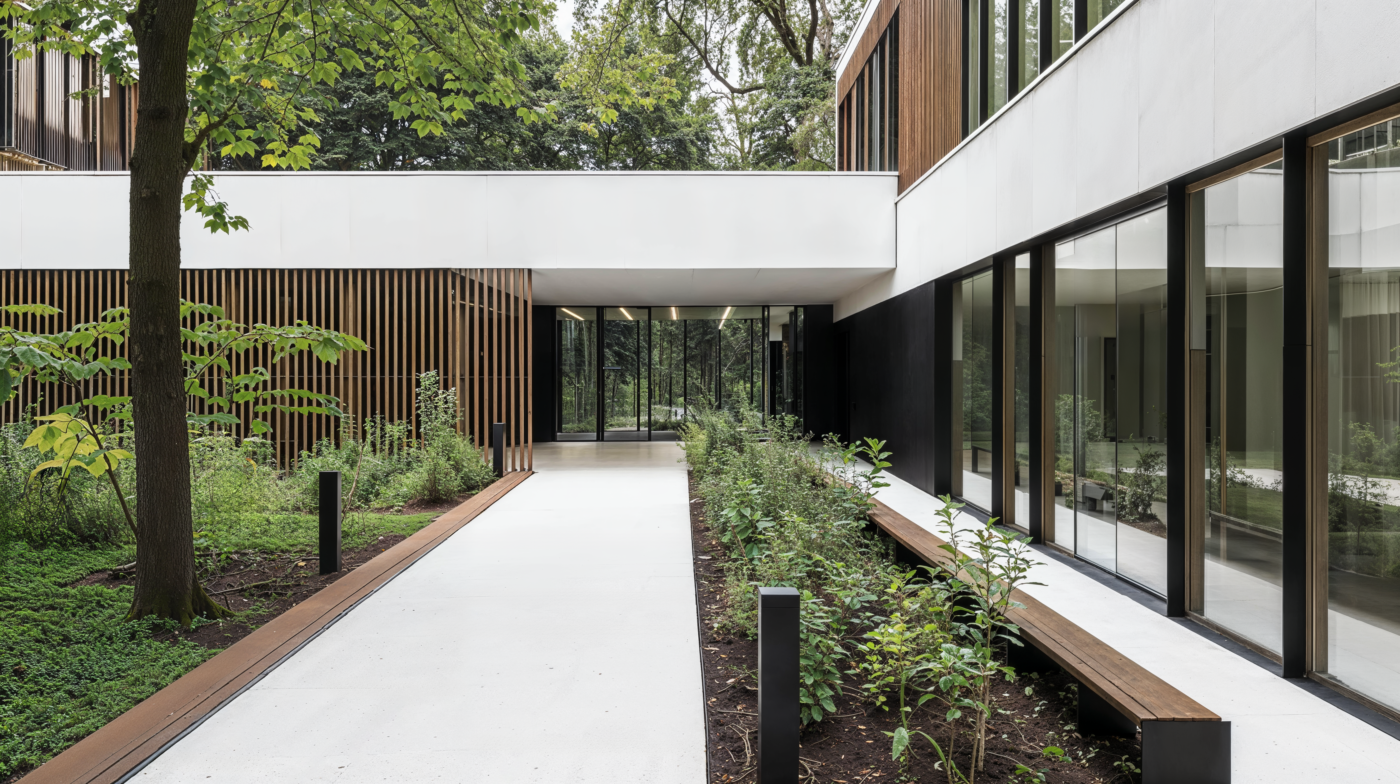 Exterior of a building that is a biophilic healing space with wood paneling along the side of the building. Large floor to ceiling windows allow for views of the surrounding landscape to bring the green space in.