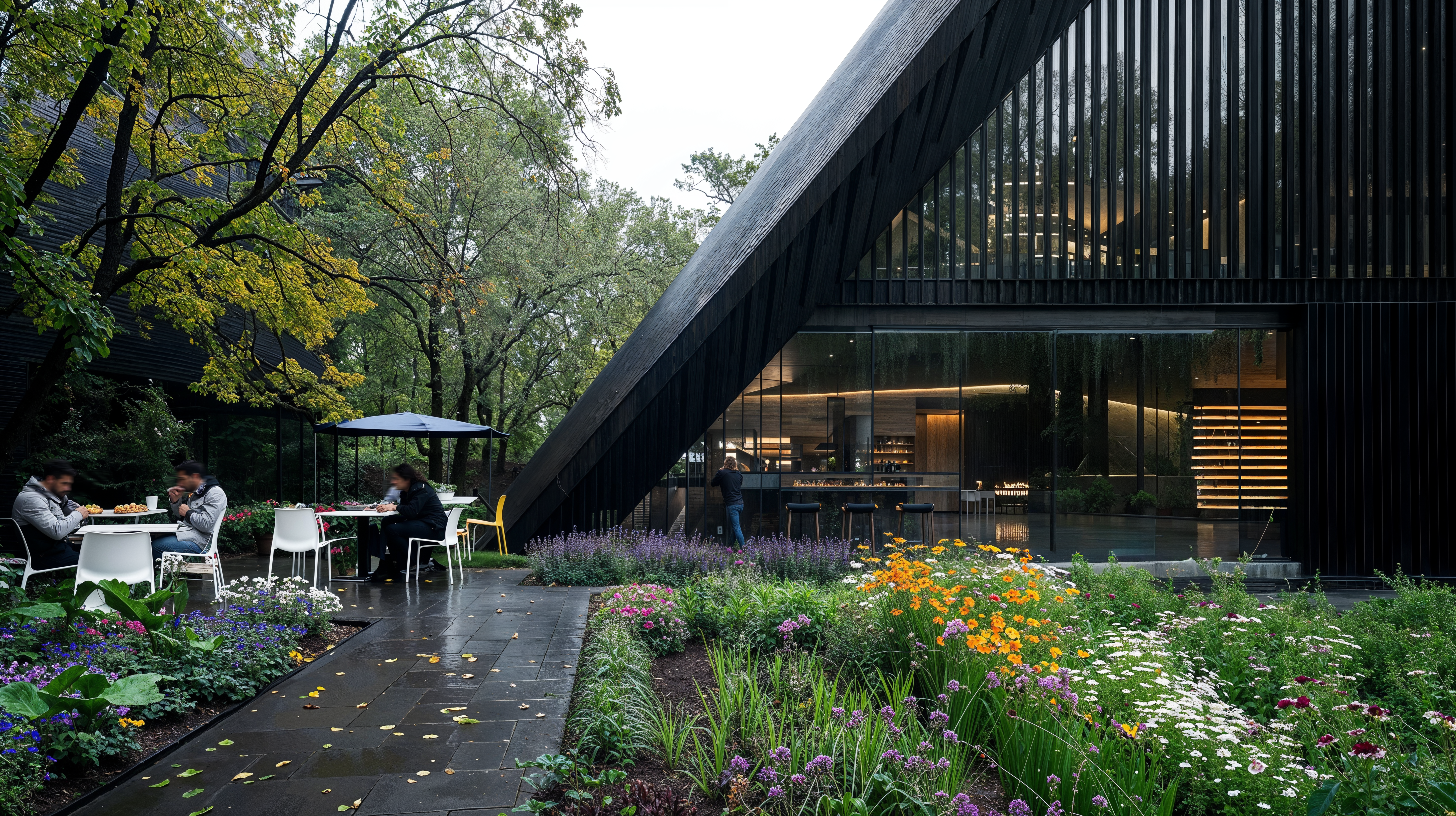 A botanical garden cafe with an A frame design with dining areas both inside and and out. Stone walkways with flowers surrounding the exterior.