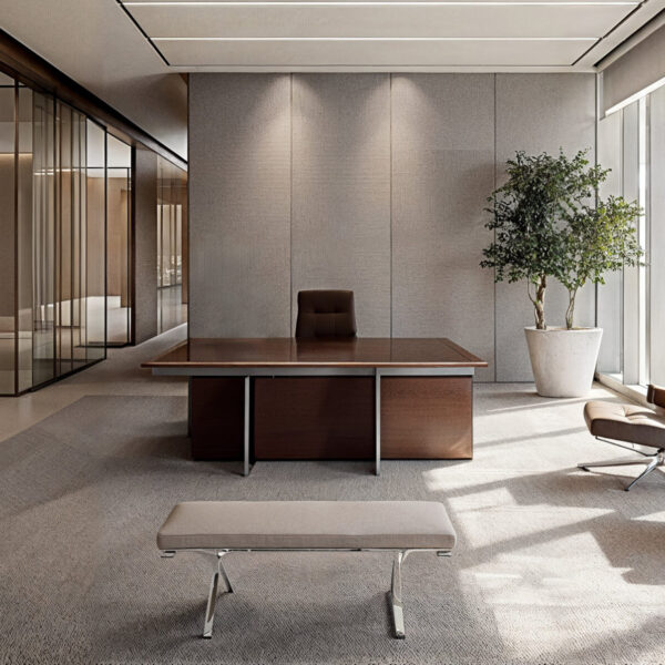 A neutral tone office space with beige floors with large area rugs and tile. A large wooden desk with dark brown leather chairs 2 in the room and one behind the desk.