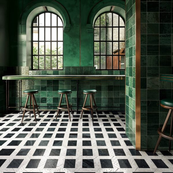 Restaurant with emerald green tiled walls and black and white floors.