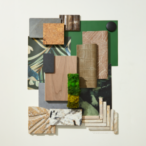 A flatlay photograph with botanical wallcoverings, bone colored tiles, and natural woods.