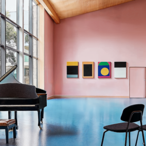 A postmodern music hall with blue flooring, large windows, and pop-art decor.