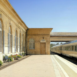A French provencal designed train station with limestone walls, wooden doors, and brick walkways.