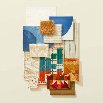 A flatlay photograph with red speckled tiles, lush colored textiles, and ornate wallcoverings.