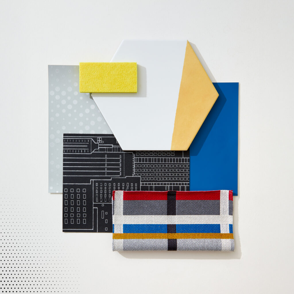 A flatlay image with yellow tile, colorful wallpaper, and blue paint.