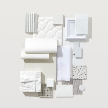 A flatlay photograph with posh textiles, bright tiles, and white woods.