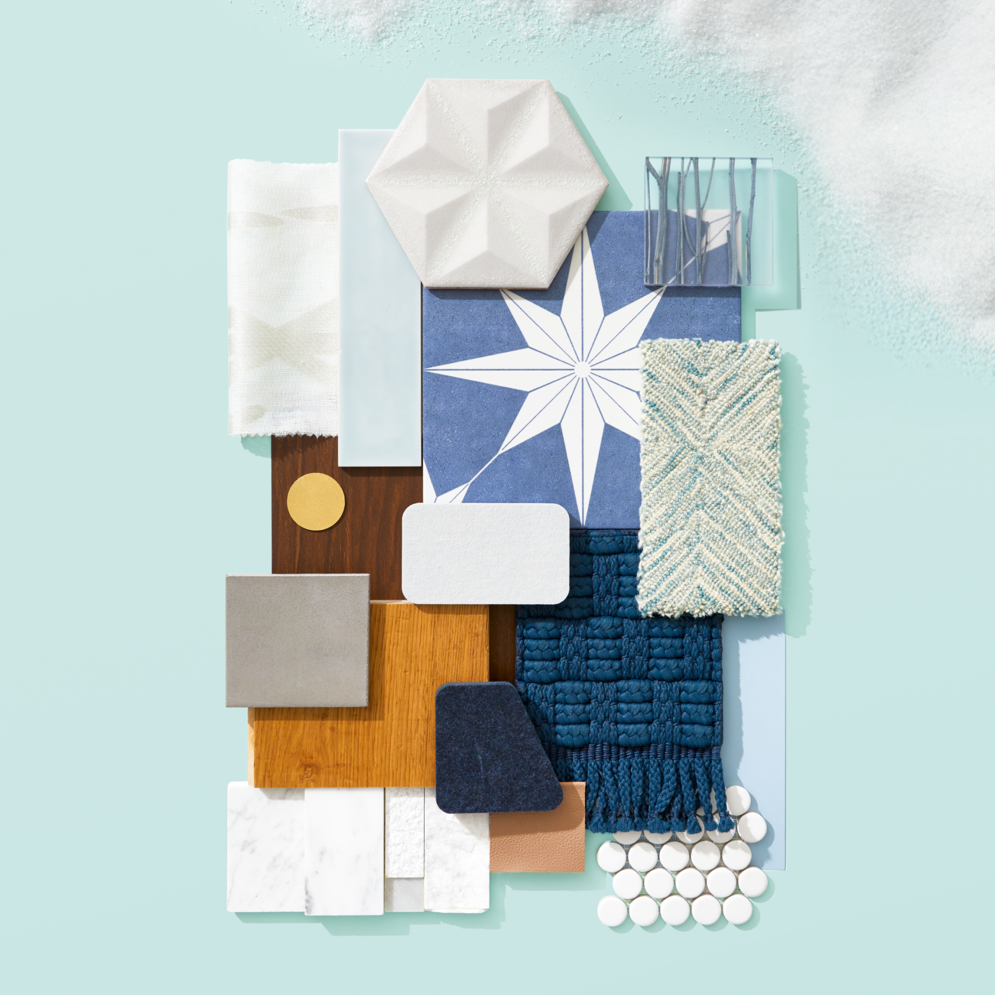 A flat lay inspired by frosted layers which incorporates a variety of materials, textures and patterns in woods, whites and shades of blue.