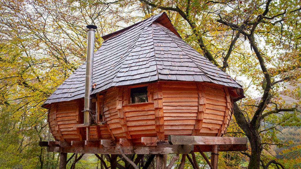 brown wooden tree house near trees during daytime