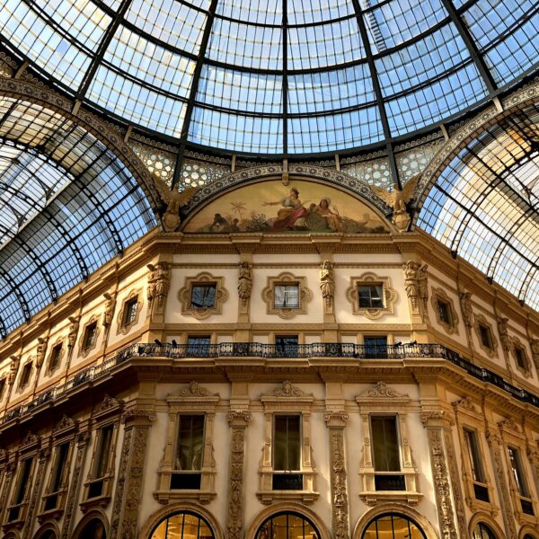 Photograph of Galleria Vittorio Emanuele II, Milan, Metropolitan City of Milan, Italy. Looking up at the building and the glass ceilings.