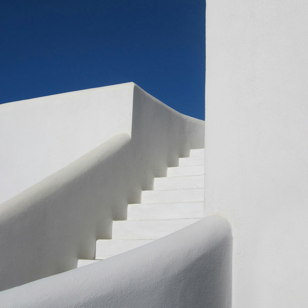 White concrete staircase under blue sky during daytime