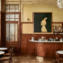 A Parisian Art Deco cafe with wooden furniture, marble countertops, and decorative chandeliers.