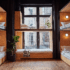 A modern dormitory with wooden wall paneling, black curtains, and warm lighting.