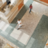 Aerial shot of a healthcare facility with Anti-Fatigue Flooring and windows letting in light as people pass each other in a hallway.